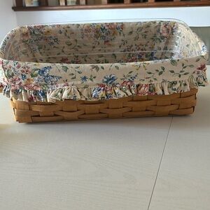 Longaberger Vanity Basket with hard plastic protector and flowered cloth liner.